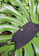 The textured black leoprint top on a big green leaf
