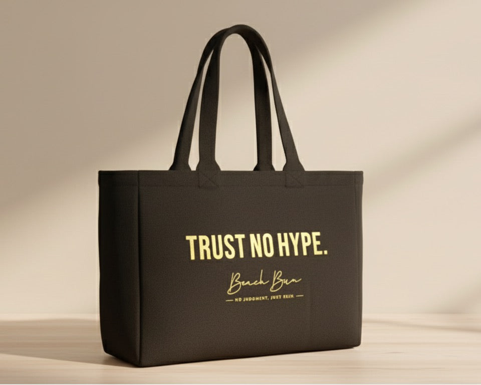 Black tote bag with 'Trust No Hype' text on a light wooden surface