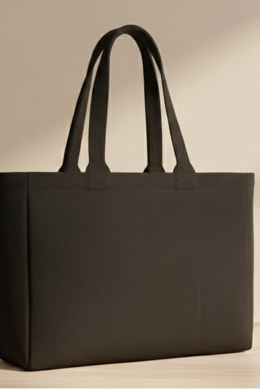 Black tote bag with 'Trust No Hype' text on a light wooden surface