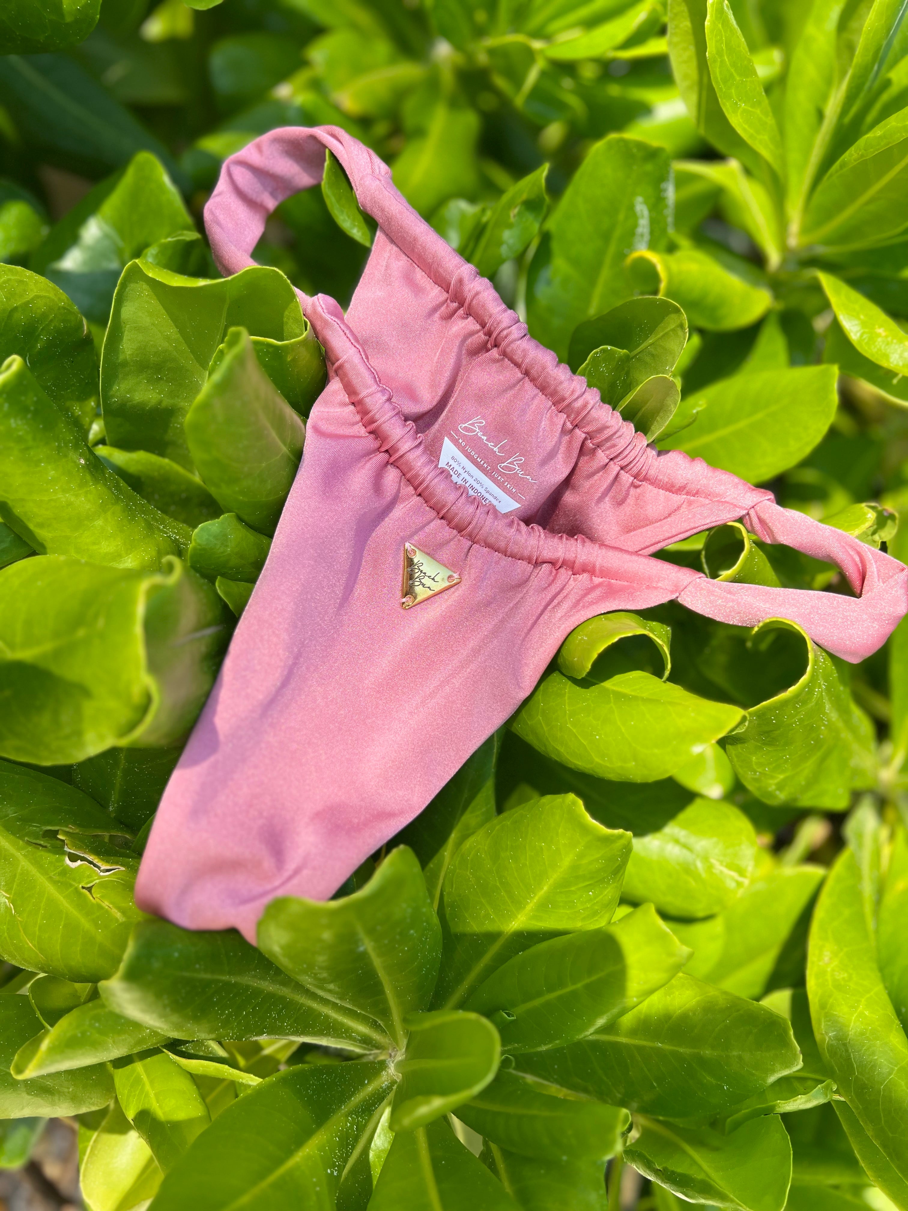 A pink highwaist bottom on plants.