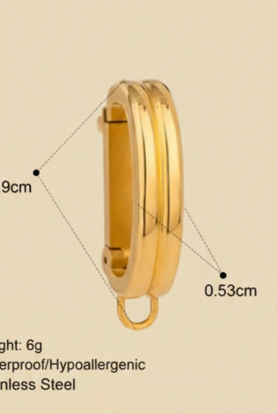 Gold bikini clip on with measurements and product details on a beige background