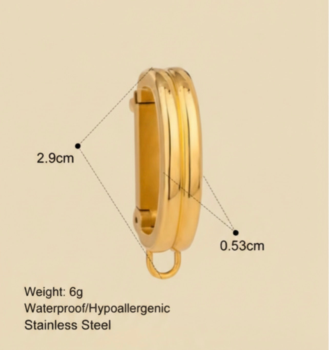 Gold bikini clip on with measurements and product details on a beige background