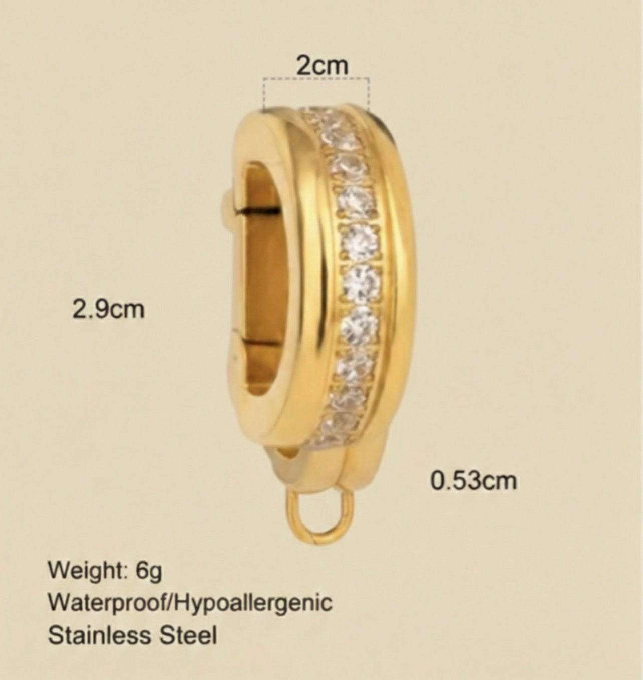Gold hoop bikini clip on  with embedded stones, shown with measurements and product details on a beige background.