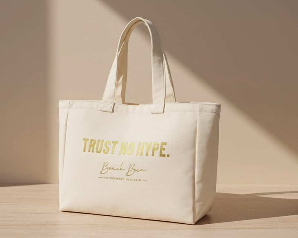 Beige tote bag with 'Trust No Hype' text on a light wooden surface