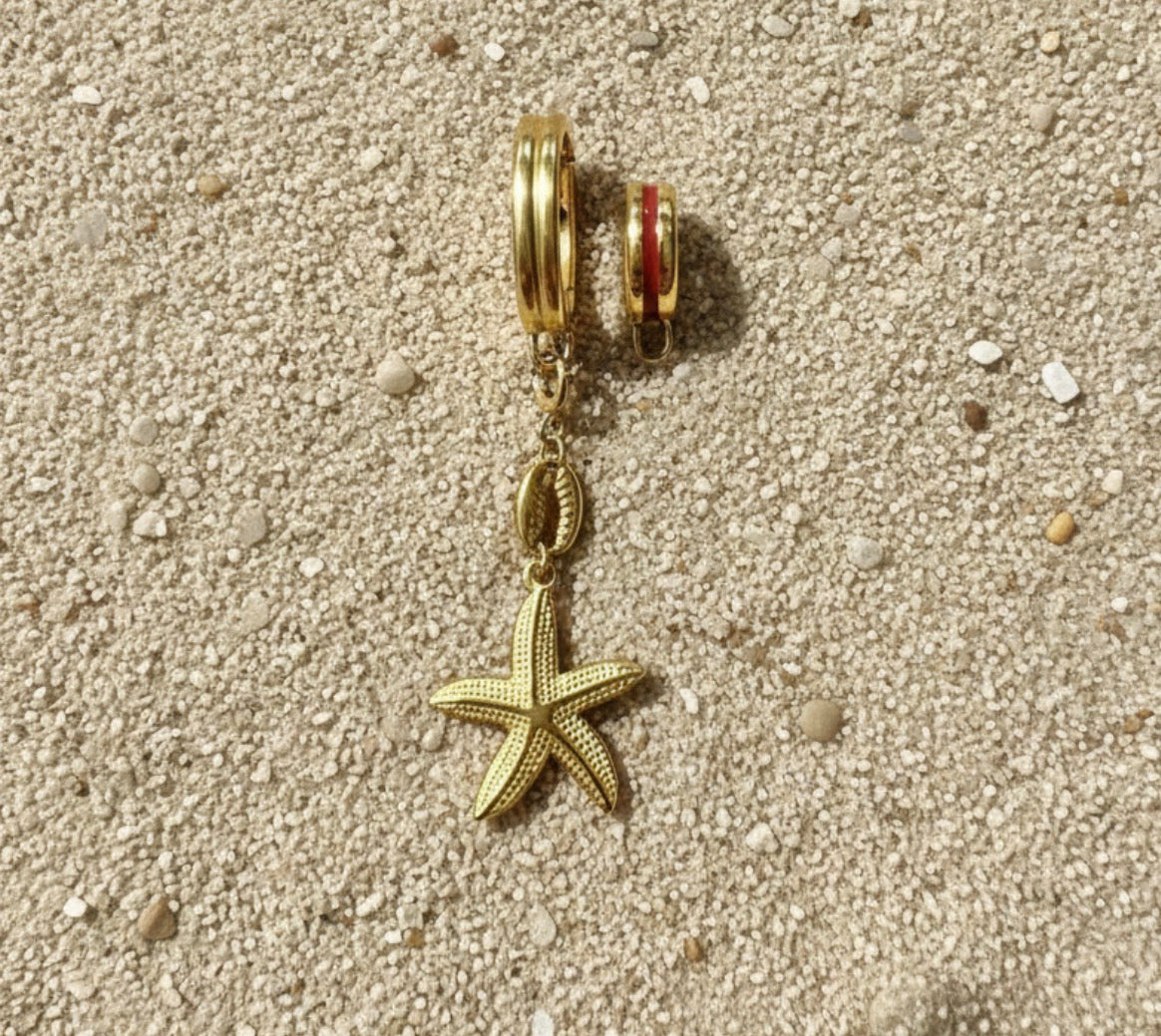Gold starfish charm on a sandy background