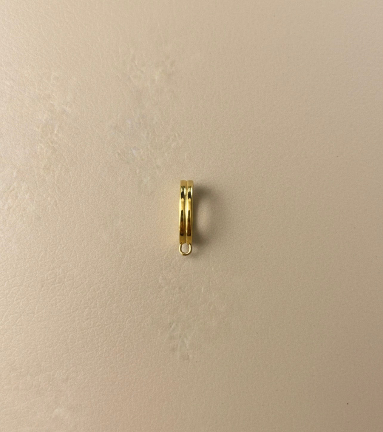 Gold Bikini clip on on a beige background